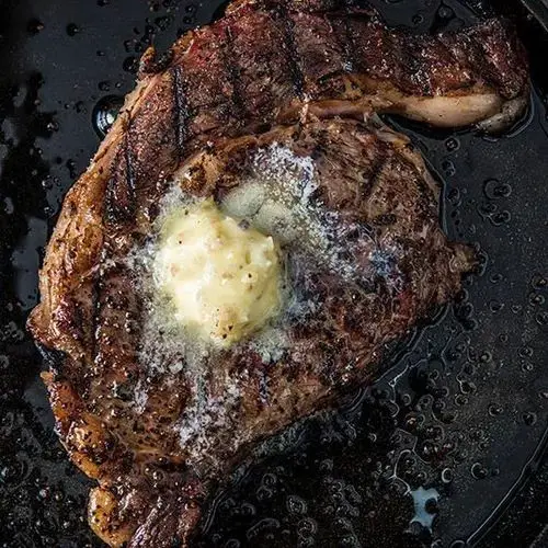 Traeger Grilled Beef Porterhouse Steak with Garlic Butter