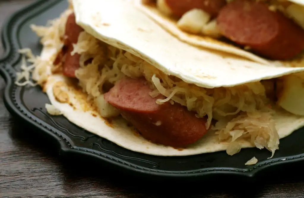 Sausage and Sauerkraut Tacos with Spicy Slaw