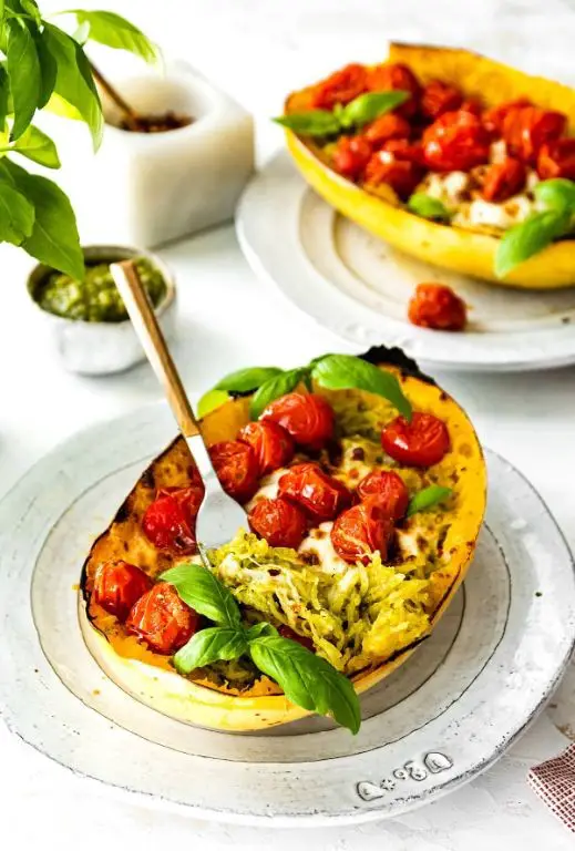 Pesto Stuffed Spaghetti Squash with Cherry Tomatoes and Mozzarella